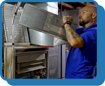 a technician replaces an air filter in a furnace system in someone's home